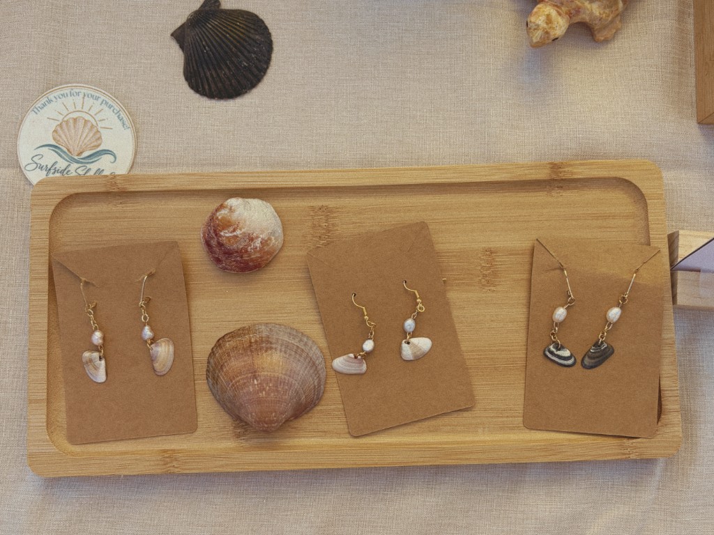Shell earrings arranged on a wooden tray
