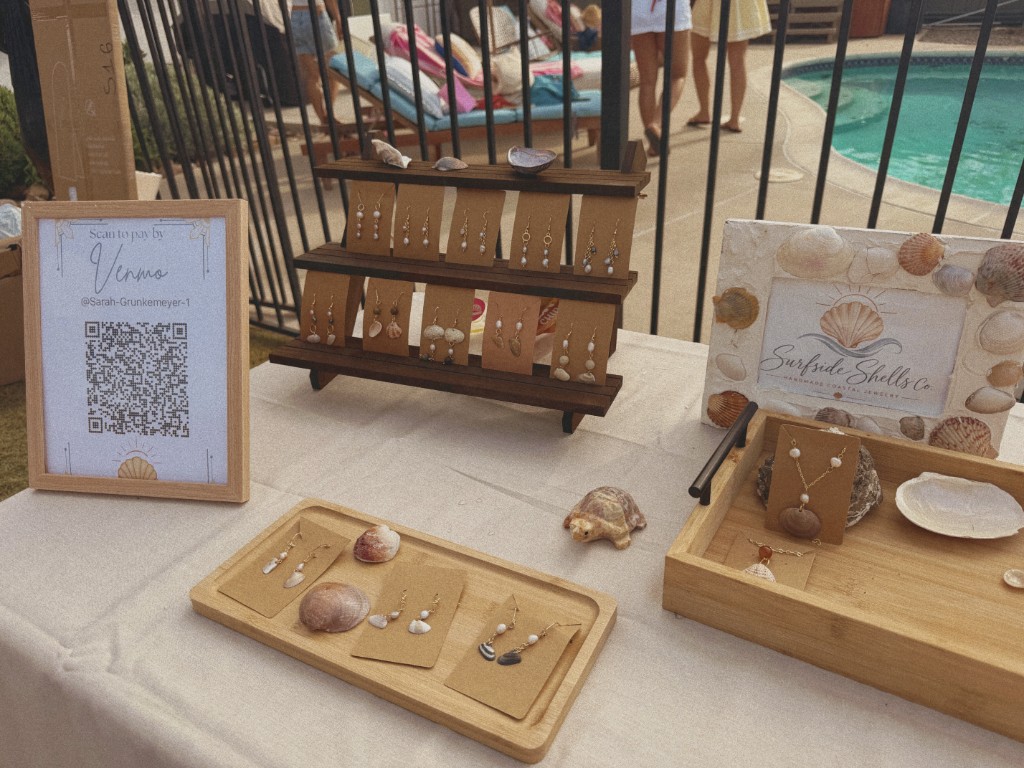 Earring stand and shells set out on a market table
