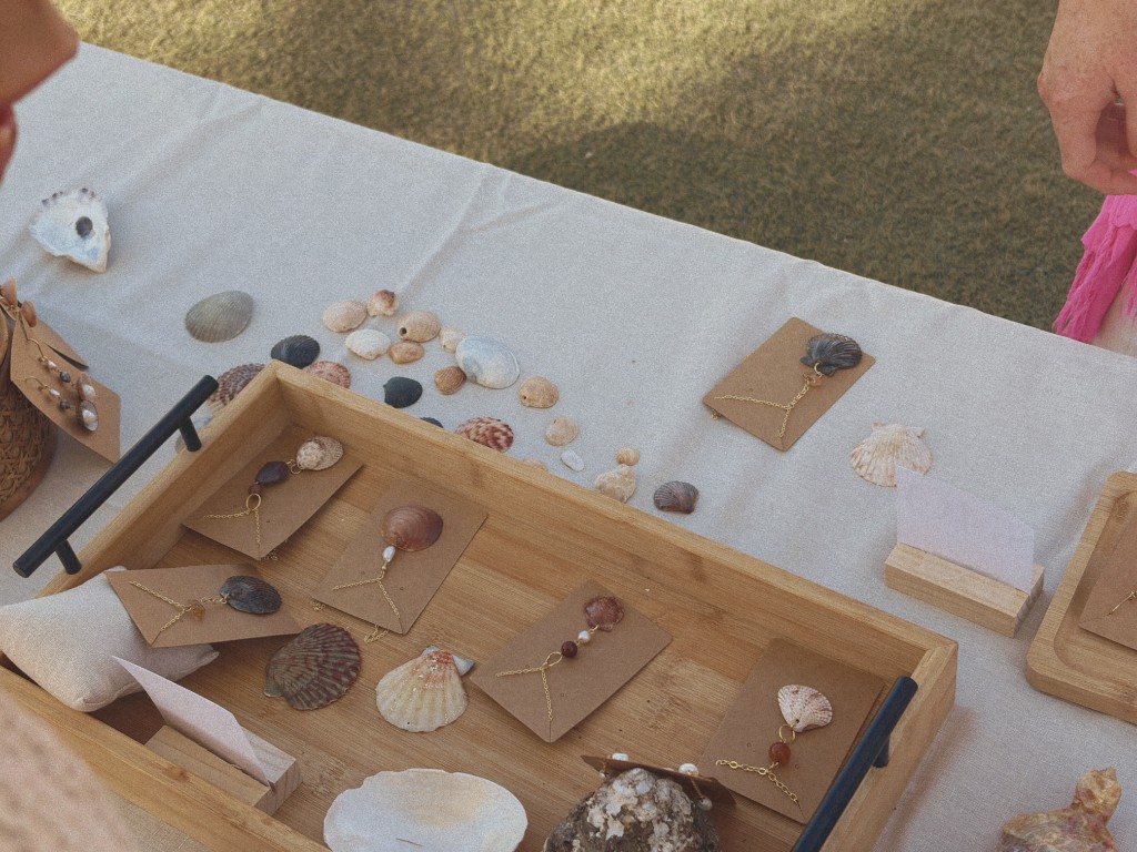 Shell necklaces laid out in a wooden tray